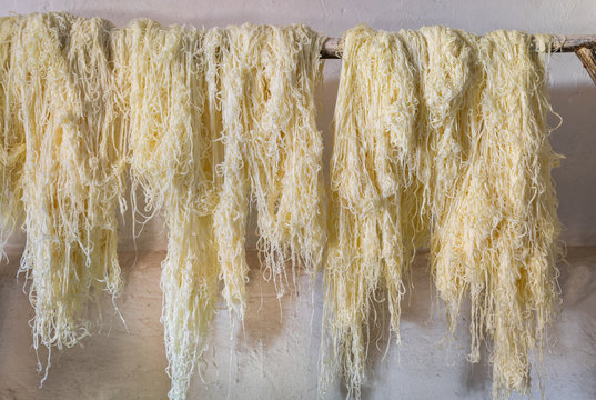 Capellini drying on wooden rod