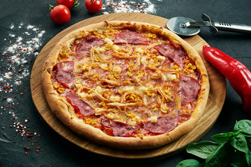 hawaiian Pizza with a large number of toppings: ham, pineapple, corn and chicken. Pizza in...
