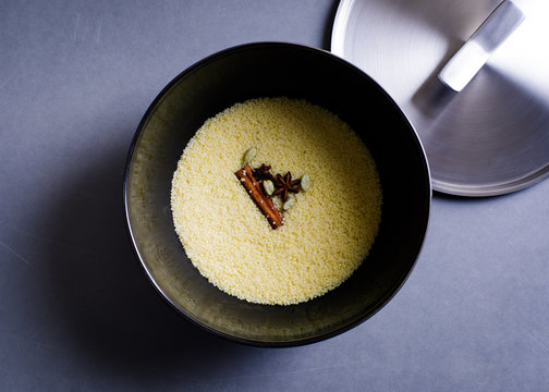 Overhead view of couscous with spices in bowl