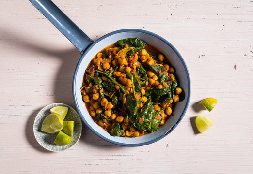 Overhead view of chickpea and kale stew in saucepan