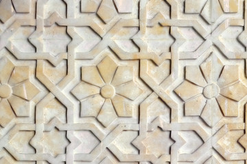 Background of flowers Arabic style, close up. Texture with African pattern on the stone wall. The...