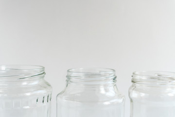 Glass jars at gray monochrome background. Zero waste concept.