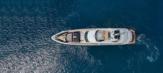 Aerial drone ultra wide photo of luxury yacht with wooden deck docked near port of Port of Fontvieille in deep blue sea, Monaco, France - obrazy, fototapety, plakaty