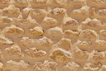 Background of sandstone bricks, retro At an archaeological site in Rome. Old brickwork masonry of limestone, texture.