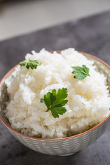 Cooked rice in bowl on kitchen table - close up
