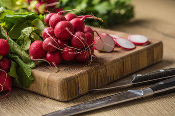 Fresh bundles of radish laid on a kitchen table