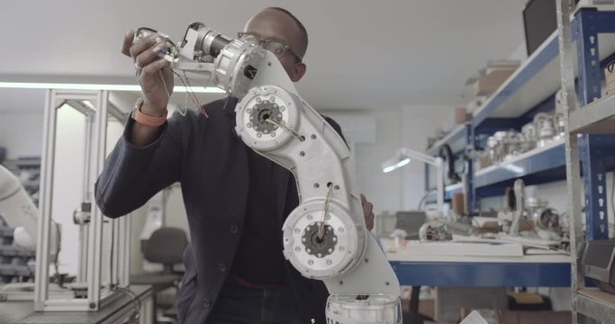 African American engineer building a robotic arm