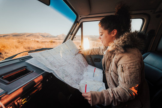Young woman looking at a map during a Californian road trip