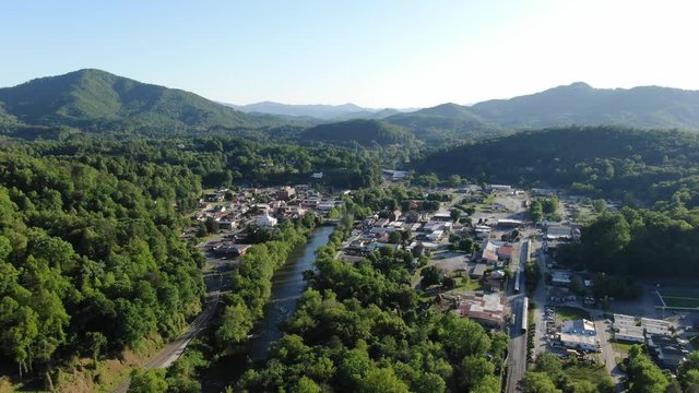 Small forested town and river in Smokey Mountains high aerial 4k pull out Mavic 2 Zoom