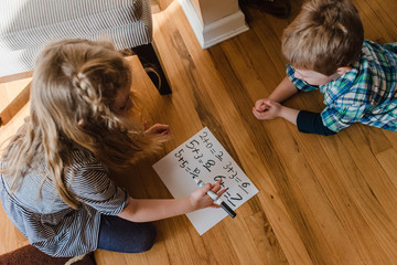 A boy and girl practice math problems.
