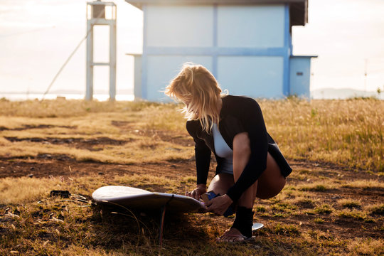 Woman preparing for surfing