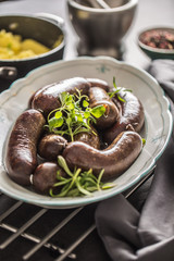 Roasted sausages in pan with rosemary. Traditional european food bratwurst jaternice or jitrnice