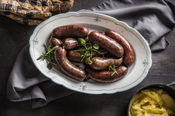 Roasted sausages in pan with rosemary. Traditional european food bratwurst jaternice or jitrnice
