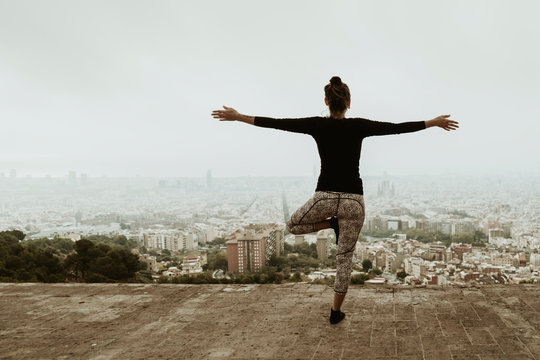 Young woman practicing yoga, asana with arms crossed. Barcelona