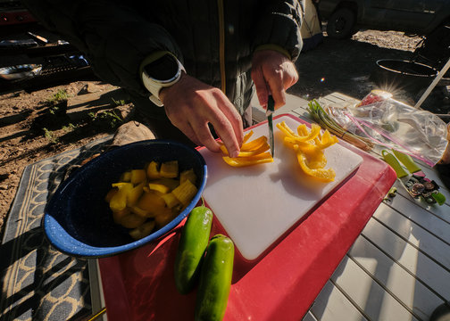 Cooking camp breakfast means cutting bell peppers.