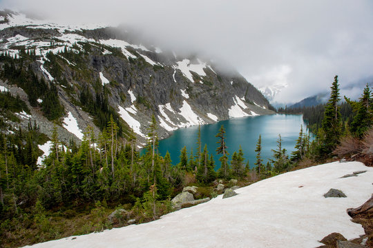 A beautiful alpine lake on a cloudy, rainy summer day in the Coast Mountains around Pemberton, British Columbia.