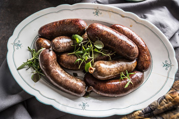 Roasted sausages in pan with rosemary. Traditional european food bratwurst jaternice or jitrnice