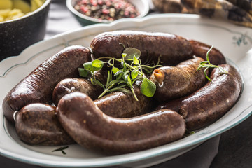 Roasted sausages in pan with rosemary. Traditional european food bratwurst jaternice or jitrnice