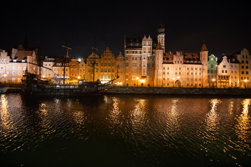 Fototapeta na wymiar Gdansk, Poland - Juny, 2019. Evening view over the river Motlawa the Old Town in Gdansk, Poland.
