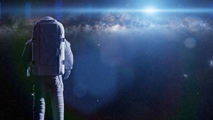 standing astronaut in front of the beautiful Milky Way galaxy © dottedyeti
