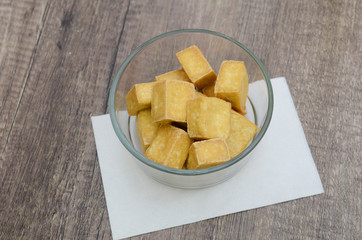 Fried cubes of bean curd (tofu) in glass bowl