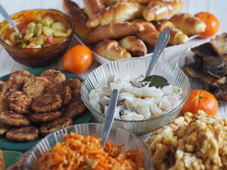 Fish diet. Fish table, XE salad of freshly salted river fish with olive oil, fish cakes, fried river fish on a wooden white rustic background or table.