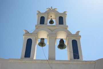 Dzwonnice kościoła na tle niebieskiego nieba - symbol Santorini - obrazy, fototapety, plakaty