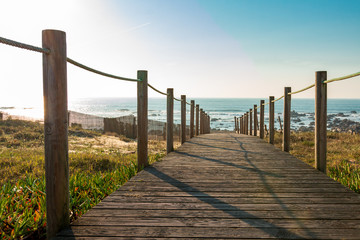 wooden walkway and fence on the beach