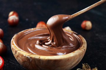 Homemade hazelnut spread in wooden bowl. Hazelnut Nougat cream with hazelnuts