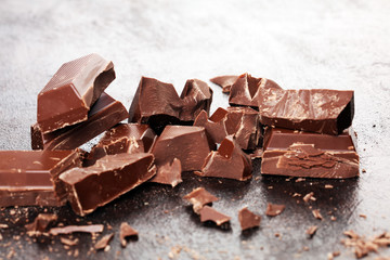 Dark chocolate stack, chips and powder with chocolate bars and block