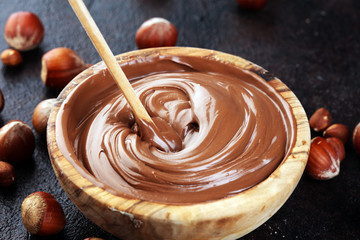 Homemade hazelnut spread in wooden bowl. Hazelnut Nougat cream with hazelnuts