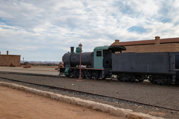 Fototapeta na wymiar Train and carriages on the Hijaz Railway line at Mada'in Saleh (Hegra), Al Ula, Saudi Arabia 