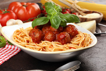 Spaghetti pasta with meatballs and tomato sauce with basil and parmesan