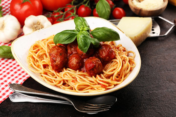 Spaghetti pasta with meatballs and tomato sauce with basil and parmesan