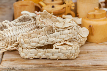 Many pairs of bast shoes on the wooden table for buying
