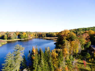 Fototapeta premium autumn landscape with lake and trees on a sunny day with colorful clouds