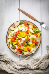 Salad with cheese and fresh vegetables.