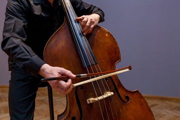A man playing on a double bass