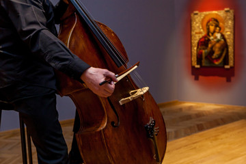 A man playing on a double bass