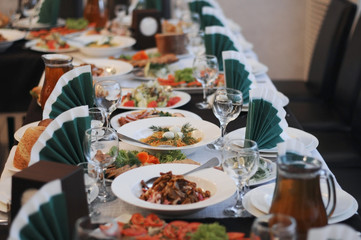 Catering table set service with silverware and glass stemware at restaurant before party