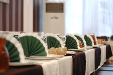 Catering table set service with silverware and glass stemware at restaurant before party