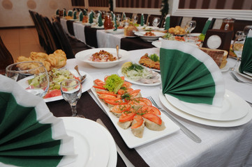 Catering table set service with silverware and glass stemware at restaurant before party