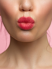 close up the beauty of female lips with natural lipstick. kiss on camera. Clean skin and makeup. beautiful girl and lip gloss