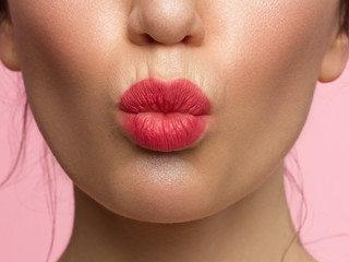 close up the beauty of female lips with natural lipstick. kiss on camera. Clean skin and makeup. beautiful girl and lip gloss