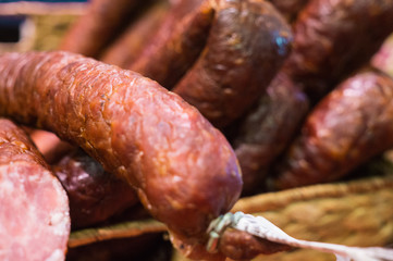 Food plat with delicious salami, pieces of sliced ham, sausage, cooked in a traditional way.