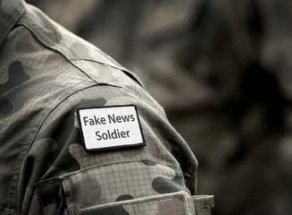 Fake News Soldier. Inscription Fake News Soldier on military uniform. Fake News Soldier Concept. Digital War.