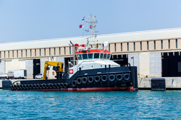 A modern tugboat moored near the pier