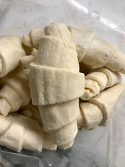 Raw Classic Crescent Rolls / Viennoiserie Dough in Plastic Bag Package Patisserie Concept.
