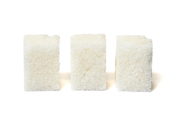 Single sugar lump with sugar crumbs isolated of white