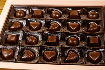 Assorted chocolate candies in a box. Close-up